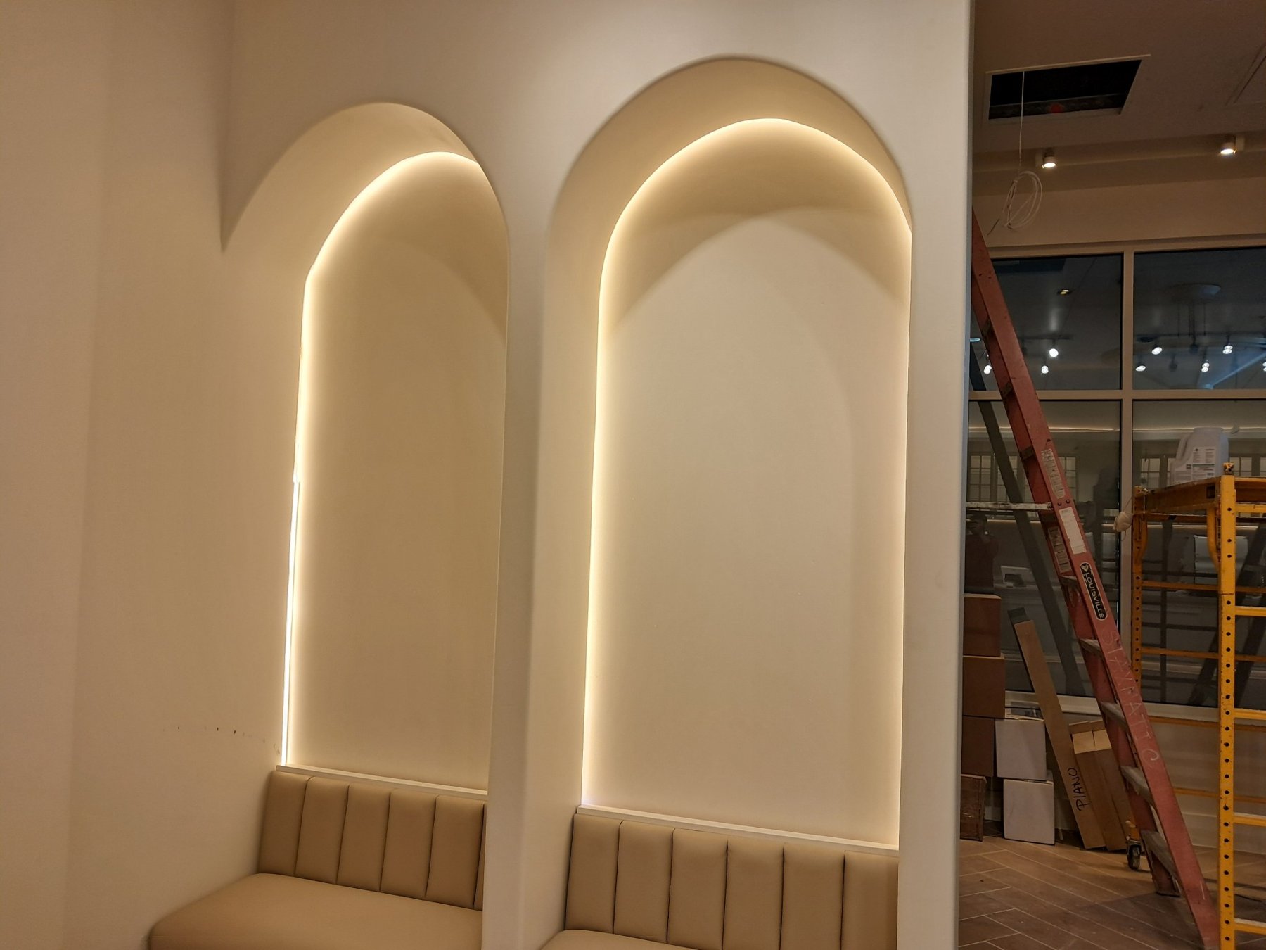 Backlit arched LED niches in a finished commercial interior